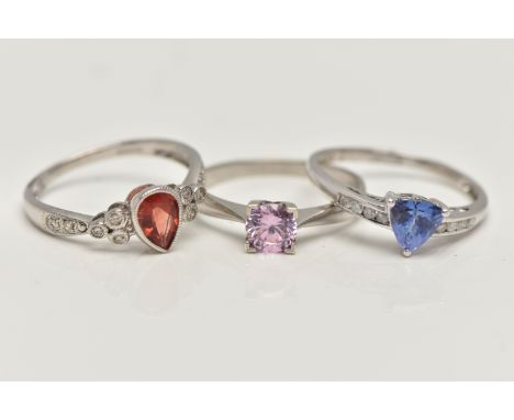 THREE 9CT WHITE GOLD GEM SET RINGS, to include a garnet and diamond ring, ring size N, a tanzanite and diamond ring, ring siz