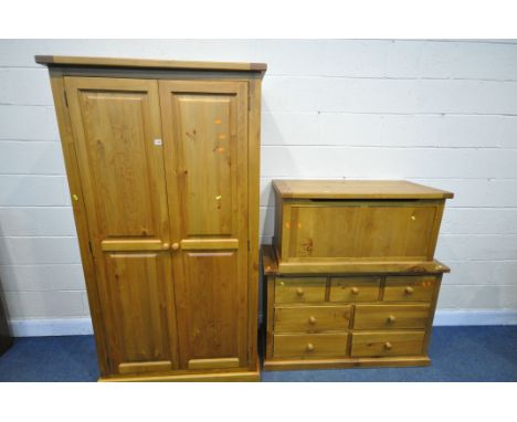 A STAINED PINE THREE PIECE BEDROOM SUITE, comprising a double door wardrobe, width 104cm x depth 52cm x height 191cm, a sideb