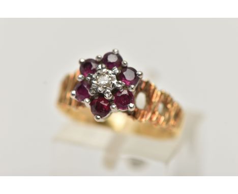 A YELLOW METAL DIAMOND AND RUBY CLUSTER RING, centrally set with a single cut diamond illusion set, within a surround of six 