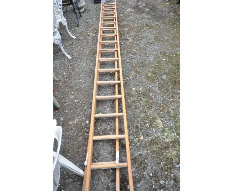 A WOODEN 32 RUNG EXTENSION LADDER, closed length 420cm (condition - appear to be only slightly used, some paint marks)