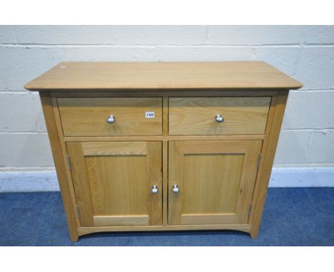 A MODERN LIGHT OAK SIDEBOARD, with two drawers, over double cupboard doors, width 98cm x depth 43cm x height 77cm (condition: