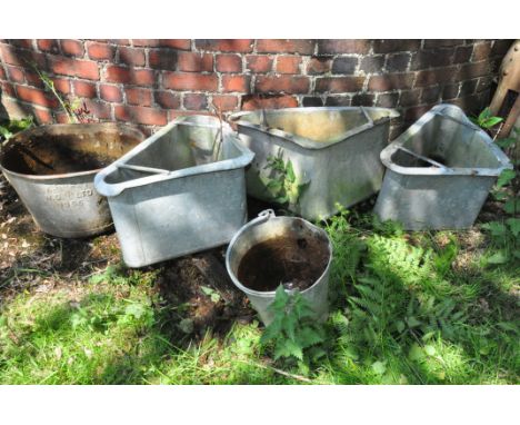 FIVE VINTAGE GALVANISED ITEMS including three quadrant water feeders 68cm across, a tub and a bucket(these items are offsite 
