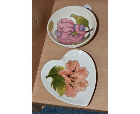 TWO MOORCROFT DISHES, one small dish decorated with a pink magnolia flower on a cream ground, a heart shaped pin dish decorat