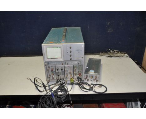A TERTRUMIX 7704A OSCILLOSCOPE SYSTEM with two Dual Trace Amplifiers, a Dual Time base, a 225MHz Universal Counter/Timer and 
