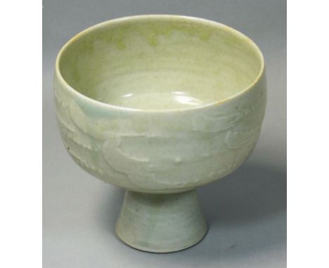 David Leach OBE (1911 - 2005), a porcelain footed bowl, pale green celadon glaze, relief scroll decoration raised on a small 