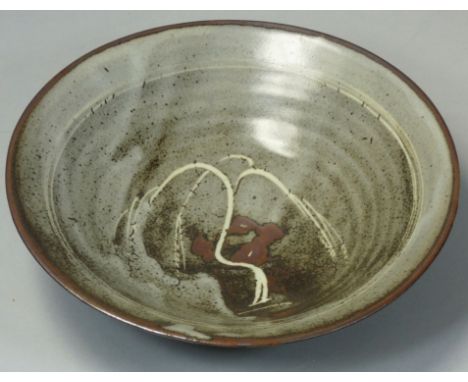 David Leach OBE (1911 - 2005), a porcelain dish, rich tenmoku glaze with thick crawling white dolomite glaze in the well and 