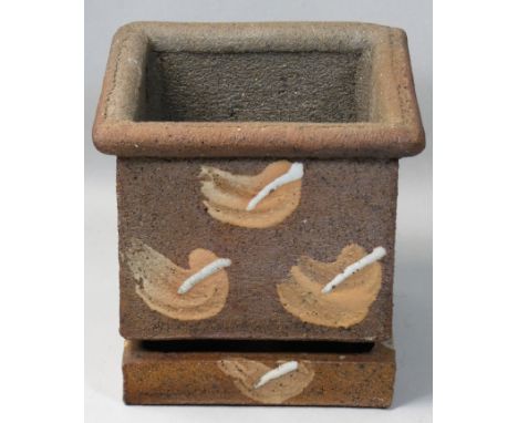 A stoneware planter with water reservoir, of square form with applied decoration, height 15cm.