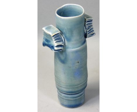 Colin Pearson (1923 - 2007), a porcelain winged cylinder vase with two applied wings, covered to the foot with a celadon glaz