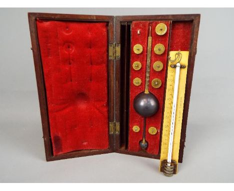A mahogany cased Sikes' Hydrometer with T. O. Blake label to lid.