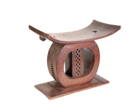 CARVED WOOD ASHANTI STOOL, 40cm high 50cm wide, circular base with pierced central column, with a brown patina 