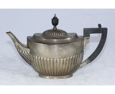 An early 20th silver teapot of oval form with half-reeded body, ebonised finial and handle, London, 1913, William Hutton &amp