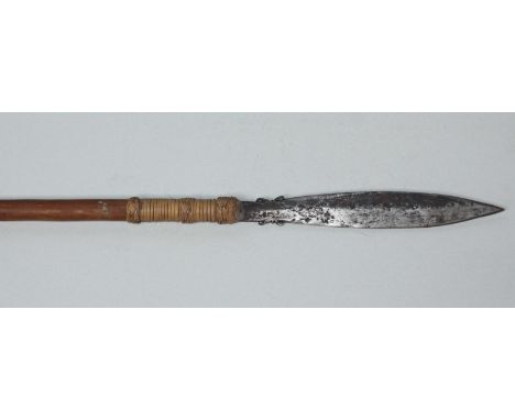 A hunting spear, possibly Indonesian, with leaf-shaped double-edged blade, rattan-bound to the rustic haft, 175cm overall