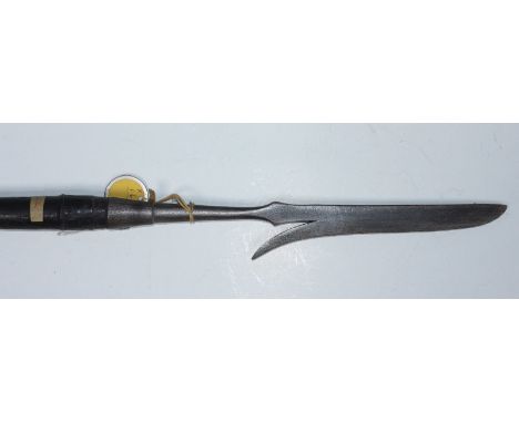 An early 20th century hunting/ fishing spear, possibly Philippines, the hand-forged spear point with single barb and iron fer