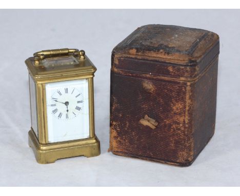 A miniature brass carriage clock, with exposed platform escapement, the white enamel dial with Roman numerals denoting hours,