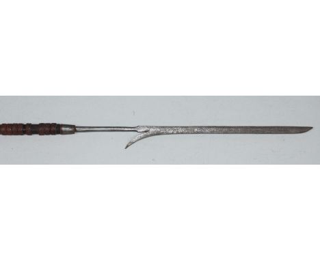An early 20th century African hunting spear, with long slender single-edged blade, single barb and tapering socket to an ebon