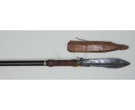 A late 19th / early 20th century Dayak combined blowpipe-spear, Borneo, with leaf-shape double-edged blade with scrolling pok