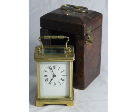 A Victorian French brass carriage clock, with exposed platform escapement, the white enamel dial with Roman numerals denoting