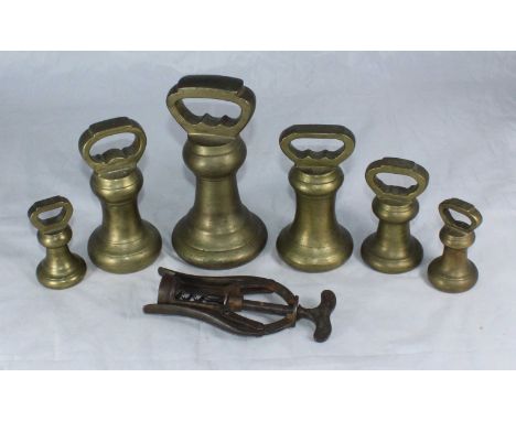 A set of six graduated brass weights together with a James Neeley &amp; Sons A1 double lever corkscrew