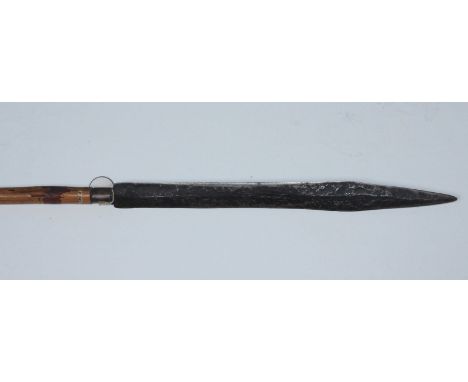 An Indonesian hunting spear with 42cm long double-edged swelling blade tapering to a point, fitted with brass ferrule to a ba