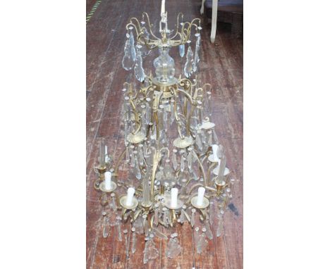A brass three-tier, nine-light chandelier with glass drops, 90cm high. (AF)