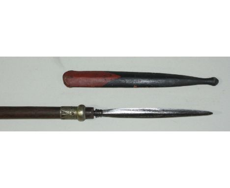 An Indonesian pole arm spear, the 25cm long blade of flattened diamond section, retaining original black and red painted wood