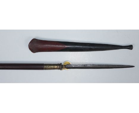 An Indonesian hunting spear, with 25cm long double-edged Pamor blade of flattened diamond section, brass ferrule and stained 