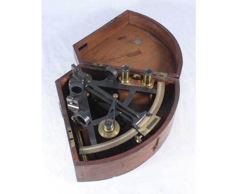 An early 20th century lacquered metal and brass sextant with various fitted brass lens and filters, in fitted mahogany box wi