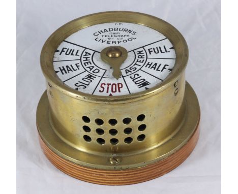 A Chadburn's Ships Telegraph, Liverpool, in circular brass case with white enamel dial on wooden mount, 20cm diam