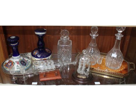 Three assorted glass decanters and stoppers, together with a glass ship in a bottle and another glass ship, two Pusser's rum 