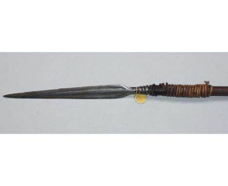 An early 20th century North African hunting spear, with 38cm iron blade of elongated leaf form with double fuller and decorat