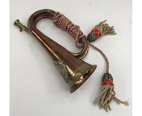 A vintage military style brass and copper bugle. Fitted with a brass Argyll & Sutherland Highlanders badge, a detachable mout