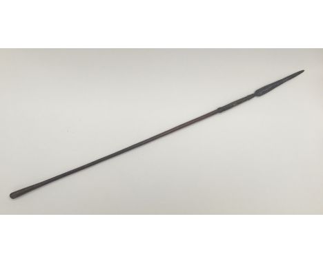 A 19th century South African throwing spear, possibly a Zulu Iklwa. Polished wooden shaft with flared end, and simple ring de