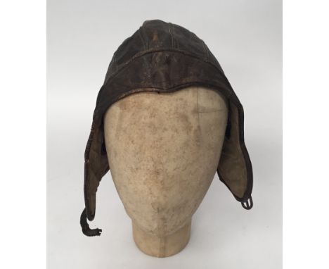 An unusual WW2 era, Chinese made, leather flying hat. 5 panel construction to the crown, with flush leather flaps that cover 