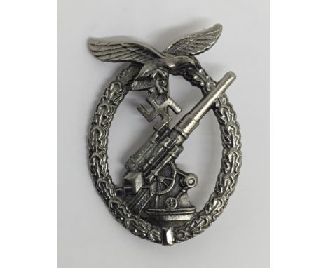 WW2 style nickel silver Flak badge by Bremner. Solid back with stamp ‘Bremner Markneukirchen’ Possible reproduction. Conditio