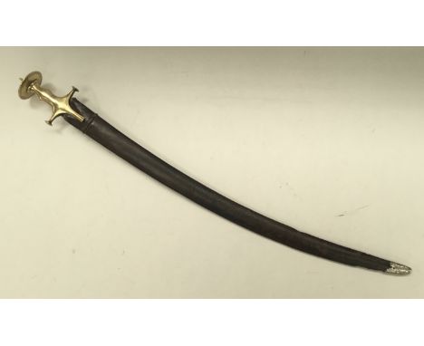 A 19th century Indian talwar sword. Typical form, with brass handle, convex quillons, and disc pommel with spike attachment. 