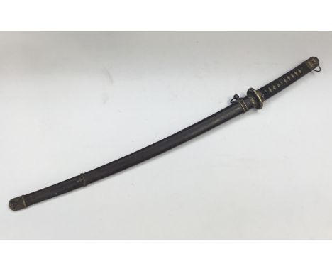 A WW2 era Japanese Katana sword. Shagreen handle with leather wrap, bronze mounts and tsuba. Lacquered scabbard with single b