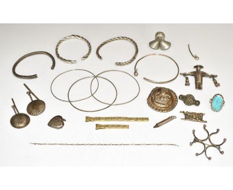 A collection of silver jewellery including three Victorian bangles, brooch, ring, Chinese brooch, locket, Japanese brooch, et