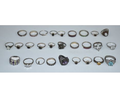 A collection of silver rings including sapphire, ruby, opal, etc