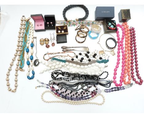 A collection of costume jewellery including bangles, two silver mounted items, beads, abalone necklace, paste earrings, pearl