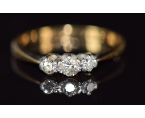 An 18ct gold ring set with three diamonds, 1.6g, size M