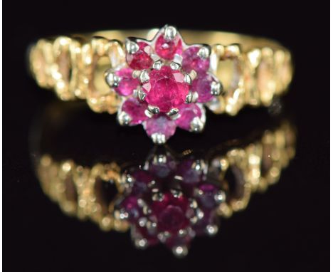 An 18ct gold ring set with rubies in a cluster, 2.4g, size K
