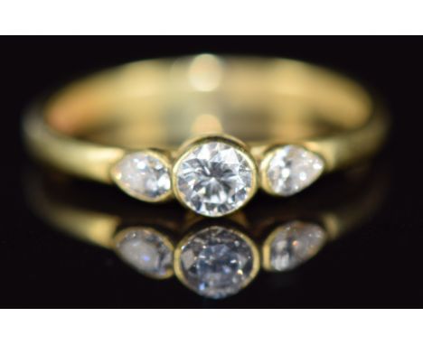 An 18ct gold ring set with a round cut diamond of approximately 0.18ct&nbsp;and two pear cut diamonds, 1.9g, size I