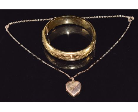 A rolled gold bangle and a 9ct gold chain (1.8g) with 9ct gold back and front locket