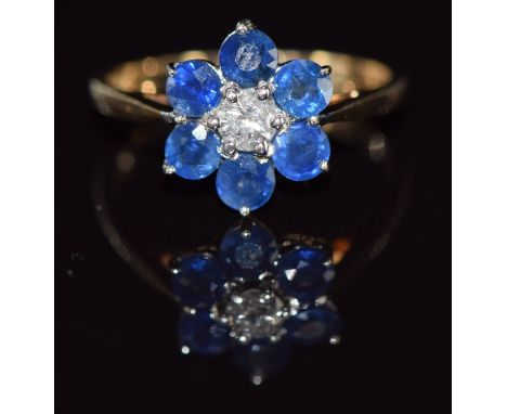 A 9ct gold ring set with a round cut diamond surrounded by sapphires, 2.7g, size P