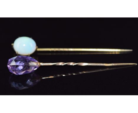 Two Victorian stick pins, one set with a briolette cut amethyst and the other an opal cabochon, 5.8cm long