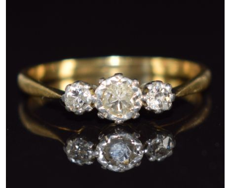 An 18ct gold ring set with three diamonds in platinum setting, 1.9g, size K