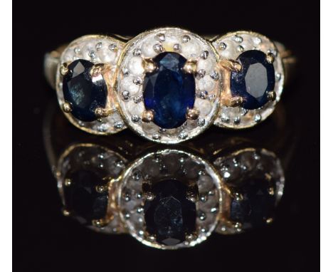 A 14k gold ring set with three sapphires and diamonds, 2.9g, size N/O