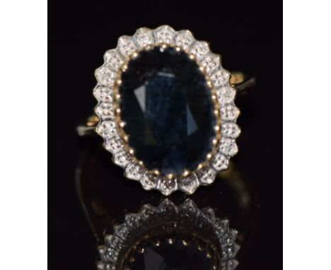 A 9ct gold ring set with a large sapphire and diamonds, 5.9g, size O