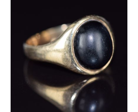 A 9ct gold signet ring set with an onyx cabochon, 4.9g, size S/T