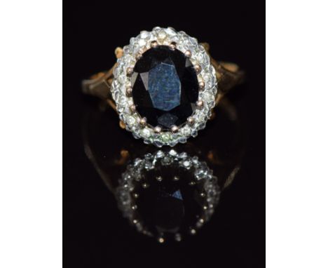 A 9ct gold ring set with a sapphire and diamonds, 3.8g, size P